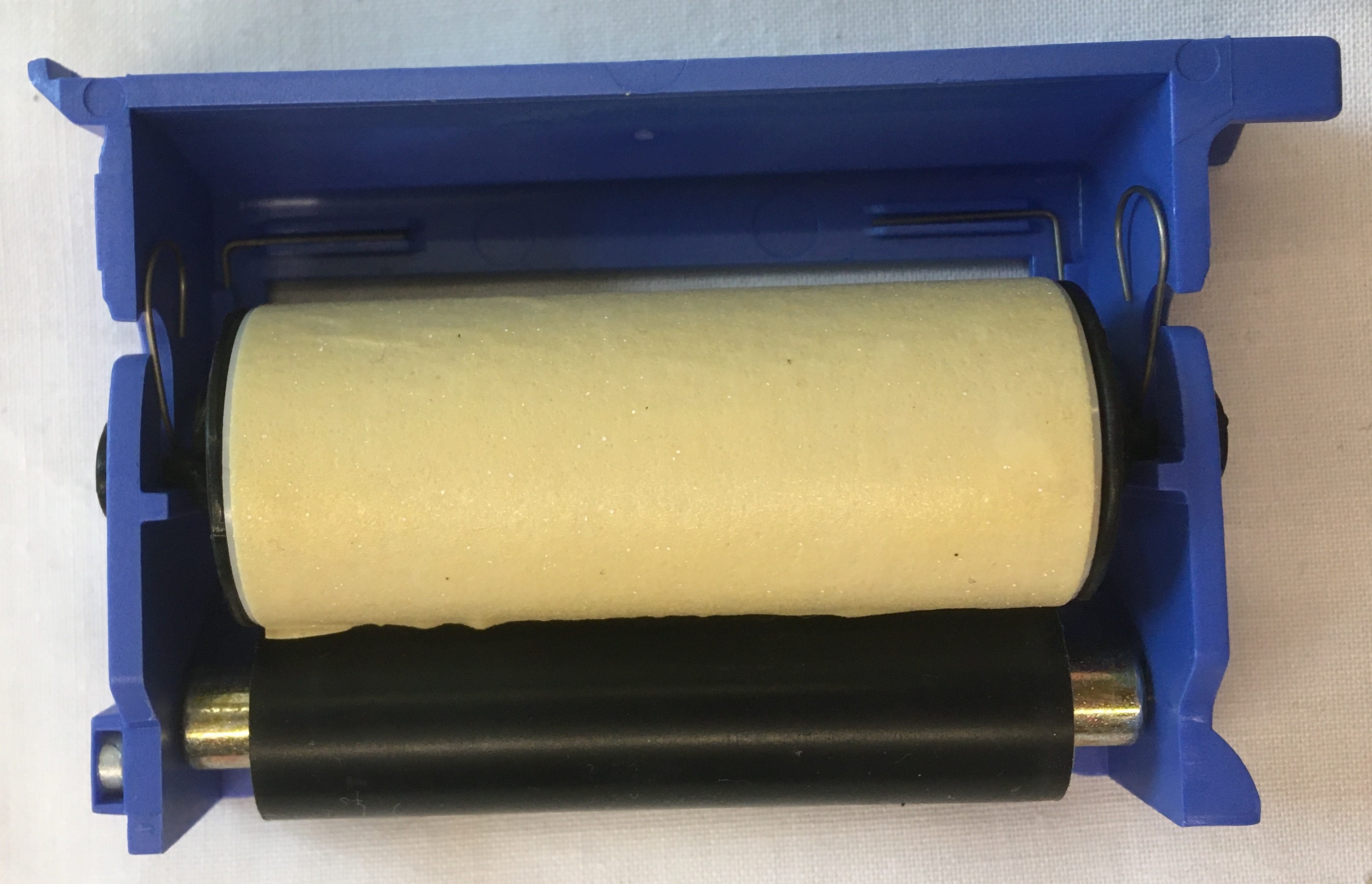 Lint Roller and Rubber Roller Secured in Blue Plastic Piece