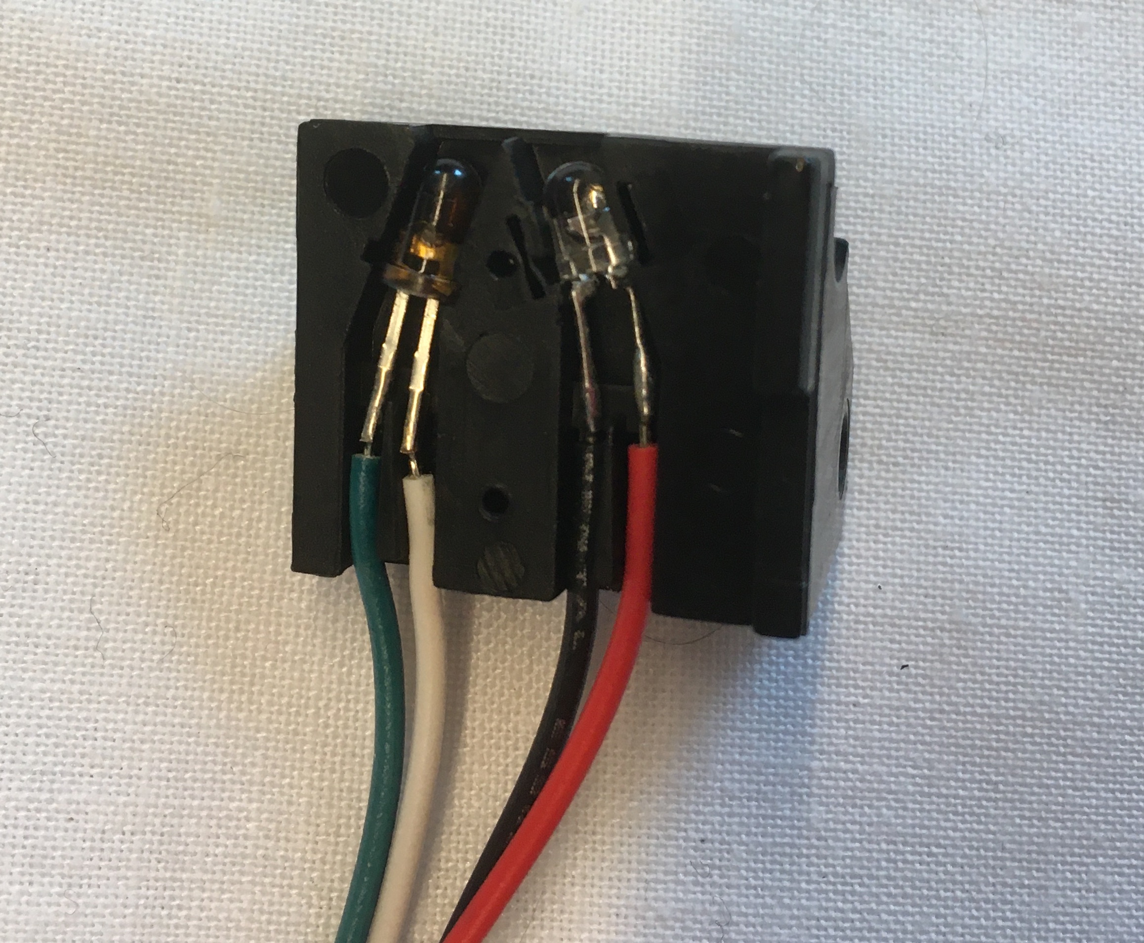 Two LEDs Laid in Plastic with Wires Leading Out From Each Terminal