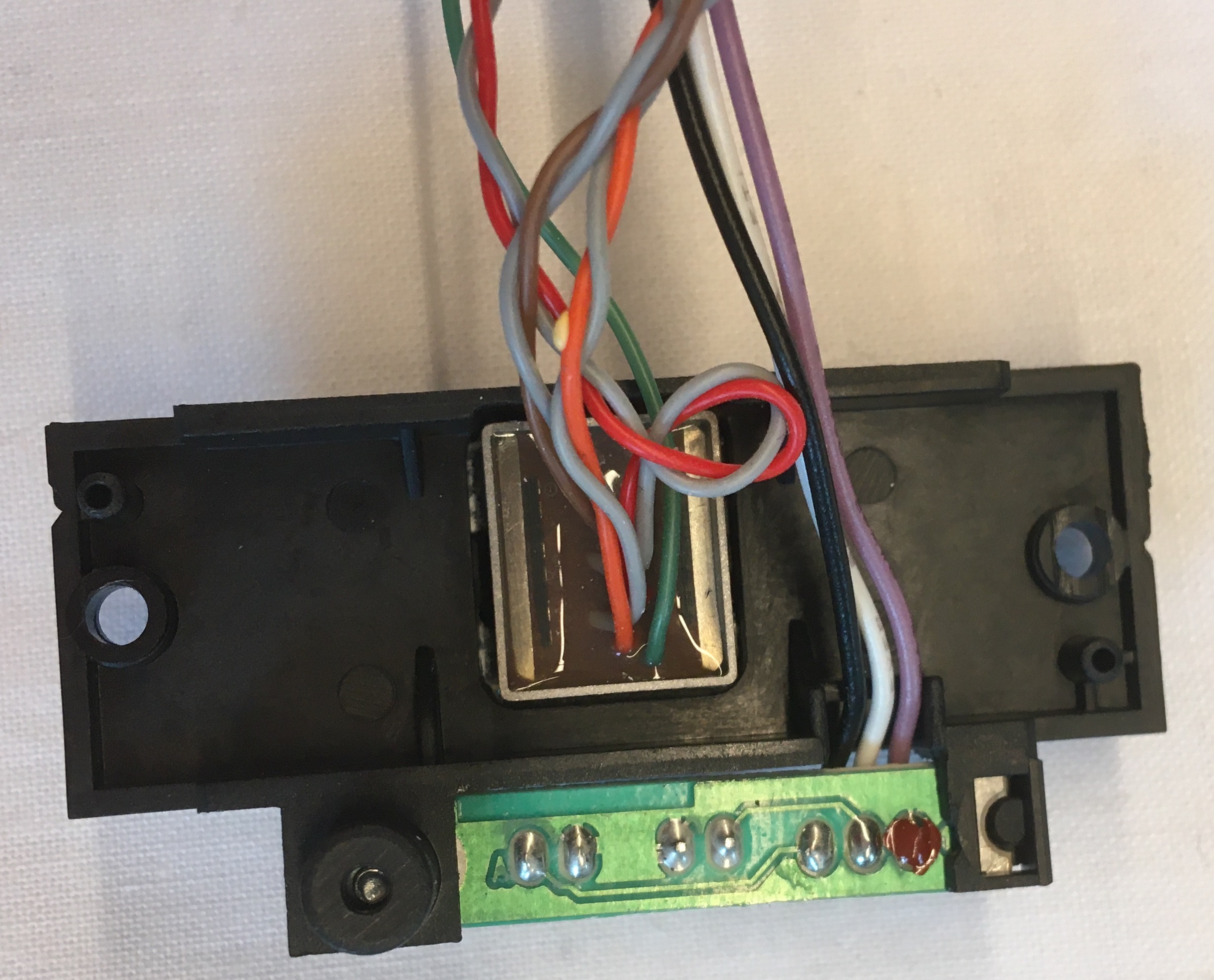 Several Wires Entering Below Metal Piece Through Epoxy Glue and Several Wires Entering PCB