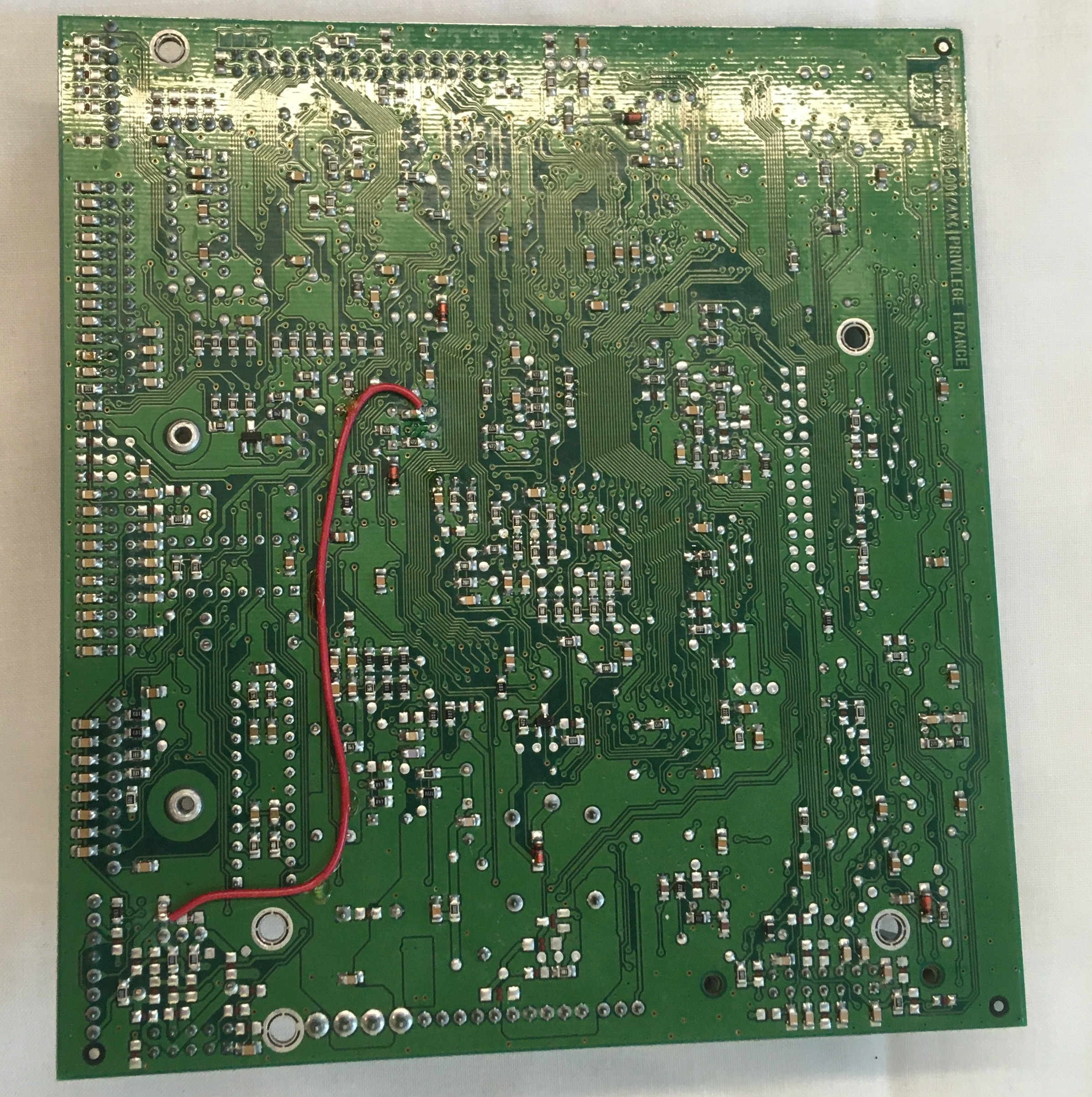 Many SMT components and One Red Wire Linking Components Across Board