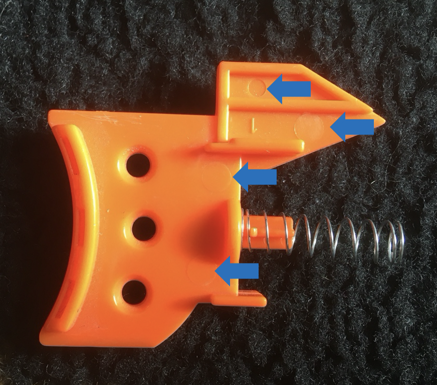 Evidence of Ejector Pin on Orange Plastic Piece