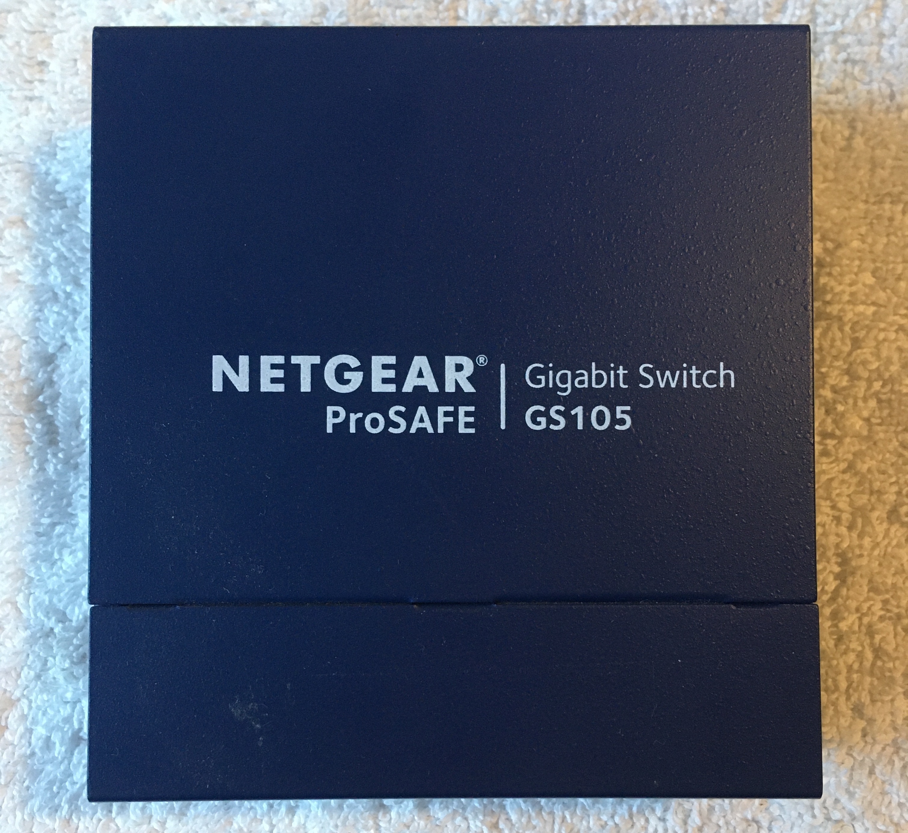 Small Blue Box Labeled 'Netgear Gigabit Switch ProSAFE GS105'